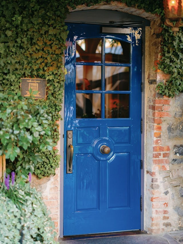 The French Laundry's blue door framed in ivy and brick