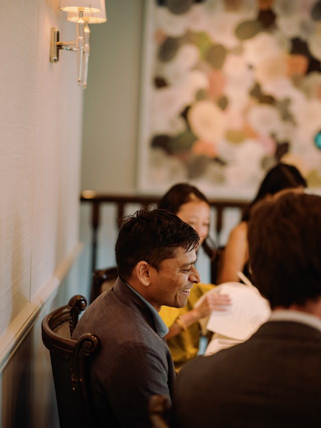 A guest laughing between courses